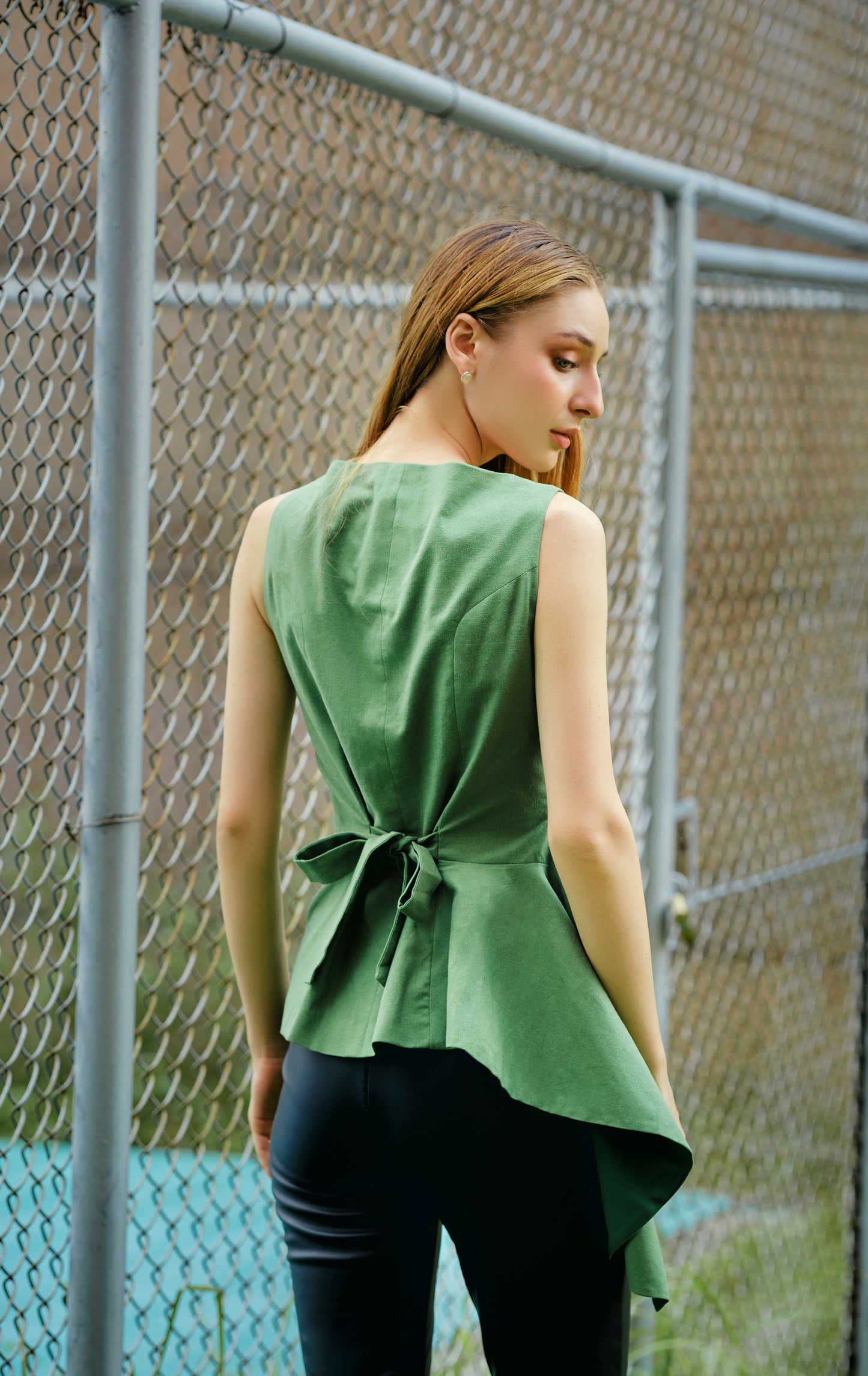 Asymmetric peplum waistcoat in green